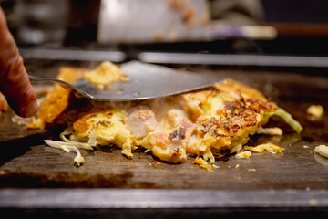 Okonomiyaki is one of Osaka’s famous foods.Teppanyaki is a Japanese cuisine that uses an iron griddle to cook food.
