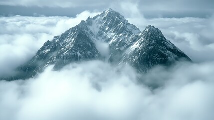 Obraz premium Snowy Peak Emerging from Cloudscape Aerial View