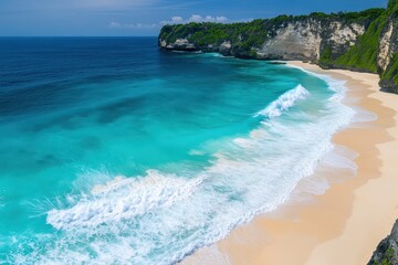 Turquoise waves crash on secluded tropical beach cliff