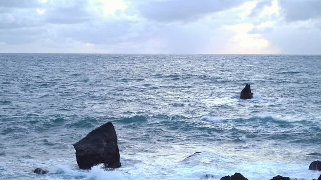 Wonderful ocean waves crush into volcanic shore rocks, Iceland at dusk - static shot