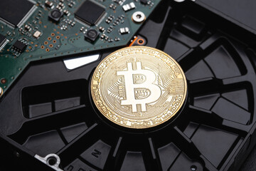 Bitcoin coin lies on the hard drive. Security concept