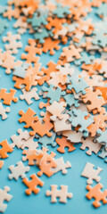 Scattered pastel puzzle pieces on blue background for creativity and problem solving concept