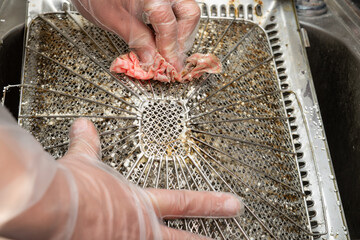 cleaning an oily filter hood from a kitchen ventilator