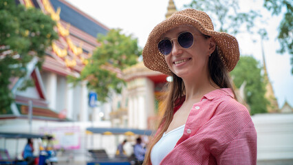 Beautiful tourist woman backpack travel in temple and local city