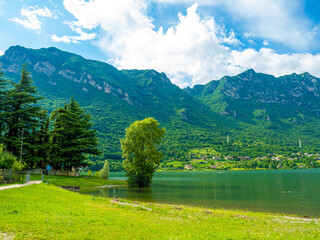Serene Lake Idro Surrounded by Majestic Mountains and Cloudy sky, Italy, Crone