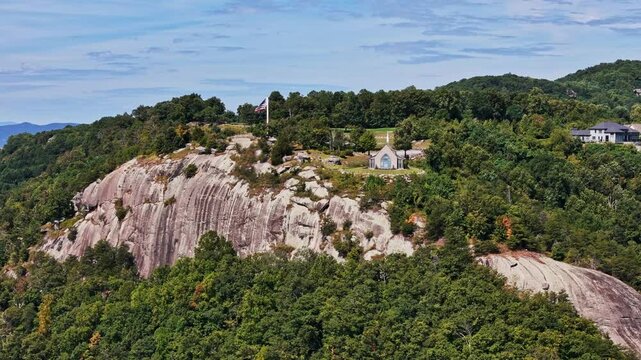 Drone approaches chapel and large American flag on the top of the Glassy Cliffs in Landrum, SC.