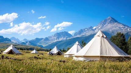 Mountain glamping tents in alpine meadow