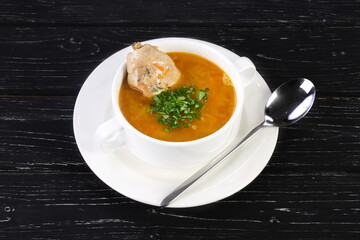 Chicken soup on wooden black background