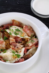 Dumplings filled with mashed potatoes on wooden black background