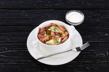 Dumplings filled with mashed potatoes on wooden black background