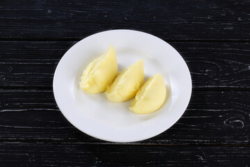 Puree on a white plate on a black background