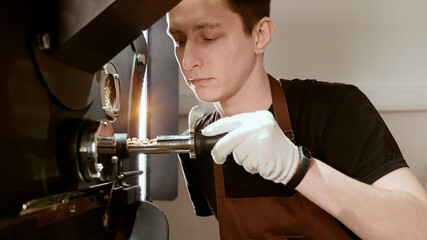 Highly Skilled Barista Operating a Coffee Roaster Machine with Expertise