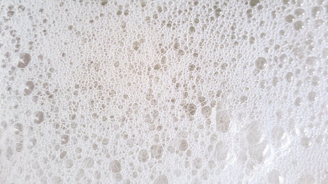 A close-up background material of lots of fine white soap bubbles