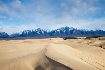 Russia. Beautiful scenery of the northernmost desert in the world. View of the Kodar Ridge. Chara sands. The region of baikaL Kodar National natural park.
