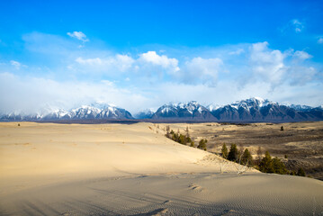 Russia. Beautiful scenery of the northernmost desert in the world. View of the Kodar Ridge. Chara sands. The region of baikaL Kodar National natural park.