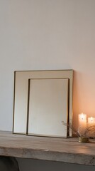 Two square mirrors on a wooden surface with candles and dried plants, creating a serene ambiance
