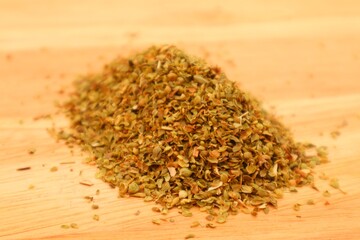 Dried oregano leaves or Origanum vulgare L. On wooden background ,close up view.

