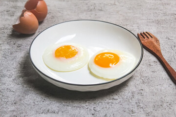 a plate of fried eggs as a breakfast menu