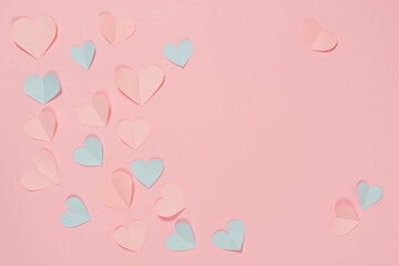 Paper pastel pink hearts on a pink background. the concept of romance, love and tenderness. Bright greeting card for Valentine's Day. Design of the anniversary of mother's Day. The view from the top.