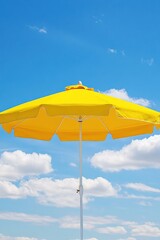 Obraz premium Sunny Day Vibes: Yellow Beach Umbrella Under a Blue Sky