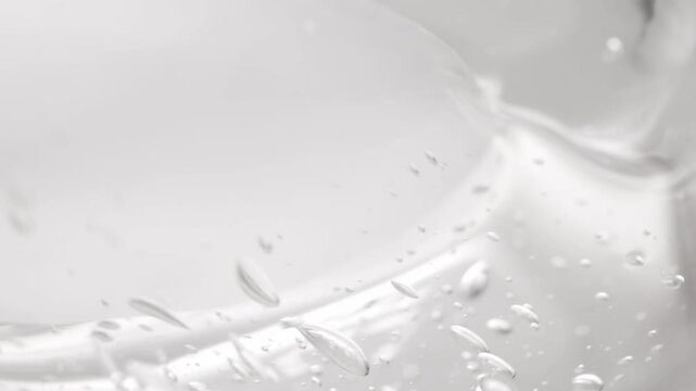 Beauty texture of hyaluronic acid close-up. Transparent serum with bubbles.