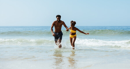 Father and daughter enjoying playful time at the seaside