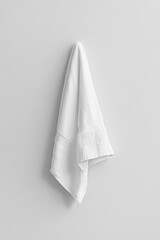 White towel hanging on a wall.