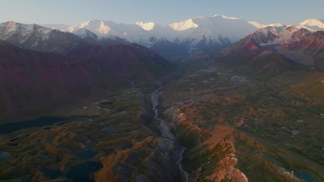 Aerial landscape of Tulpar lake and Lenin peak in a morning sunrise, Kyrgyzstan
