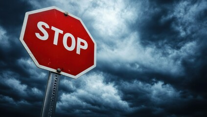 Stop sign against stormy sky.