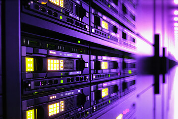 Fototapeta premium a close-up view of a server rack filled with computer servers, illuminated by purple lights