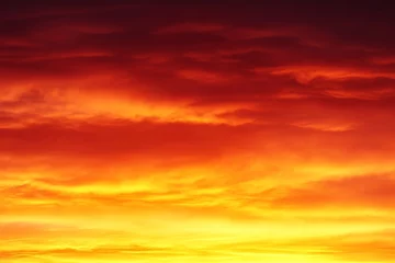 Foto op Canvas A vibrant sunset casts a fiery gradient across the sky, blending rich orange and deep red colors. This captivating display creates a breathtaking view as evening approaches, enhancing the landscape © Vitalii Shkurko