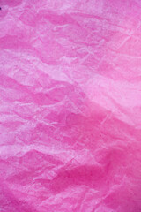 Pink crumpled paper surface background.