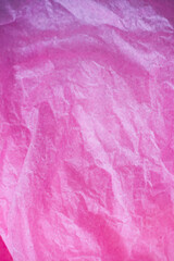 Pink crumpled paper surface background.