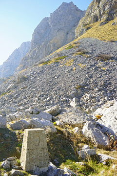 Albania-Montenegro border in Prokletije National Park: old stone border post and picturesque mountains in Buni i Jezerces. Beautiful landscape taken while hiking in Albanian Alps.