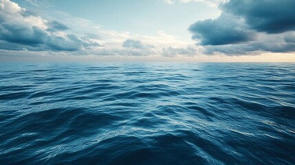 Obraz premium Vast expanse of blue ocean under a cloudy sky showing the horizon line