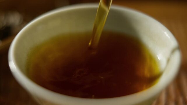 Filling a Tea Cup, Close-up of Hot Tea Being Poured