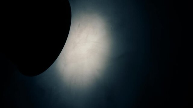 Smoke swirling in bright light