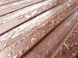 A wooden surface with water droplets on it