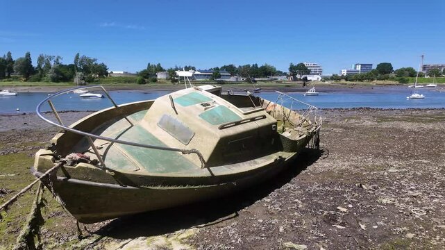 An Abandoned Boat Rests on the Muddy Shoreline in Lorient, Brittany, France - Close Up
