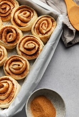 Delicious cinnamon rolls prepared for baking in a rectangular pan