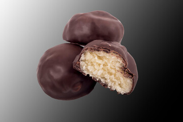 chocolate with filling inside. there are three of them. one is cut in half. close-up. there are three of them.