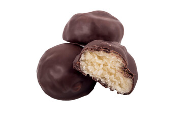 chocolate with filling inside. there are three of them. one is cut in half. close-up. there are three of them.