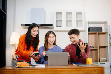 Teamwork and creativity with young adults collaborating on laptops and tablets