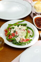 Mixed breakfast greens, tomato and curd cheese diet salad in nature salads