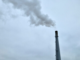 detail of a smoking industrial chimney. burning waste and gas with co2 damages the environment. a...