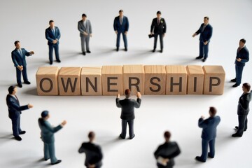 Businesspeople surrounding wooden blocks spelling 'Ownership', signifying shared responsibility and collaborative enterprise.