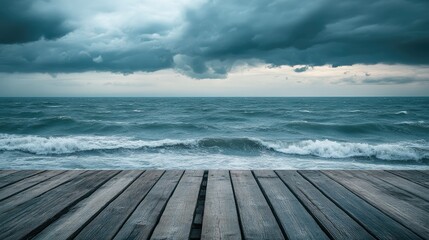 Fototapeta premium A wooden dock stretches into a turbulent ocean under a moody sky.