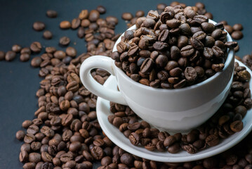 coffee in white cup and coffee beans are the background.