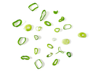 Sliced Green Onions cut isolated on white background with clipping path. Scattered Fresh Chives , Chopped Spring Leek , Scallion Green Onion Pieces. Top View Flat Lay.