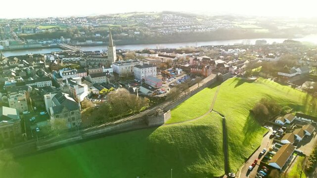 Ultra wide aerial of The Derry Walls in Derry-Londonderry, Northern Ireland on a bright sunny day. Filmed in 4K at 30fps with Rec709 color.